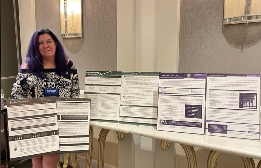 Marie PLett surrounded by samples of her award winning resumes